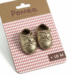 Chaussures dorées pour poupée -